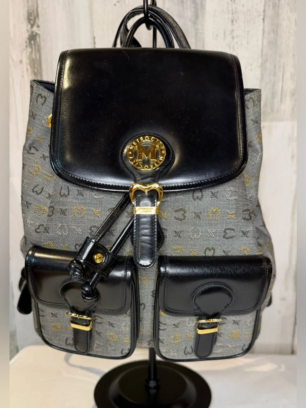 Metrocity Signature Canvas Backpack with black leather trim and gold hardware